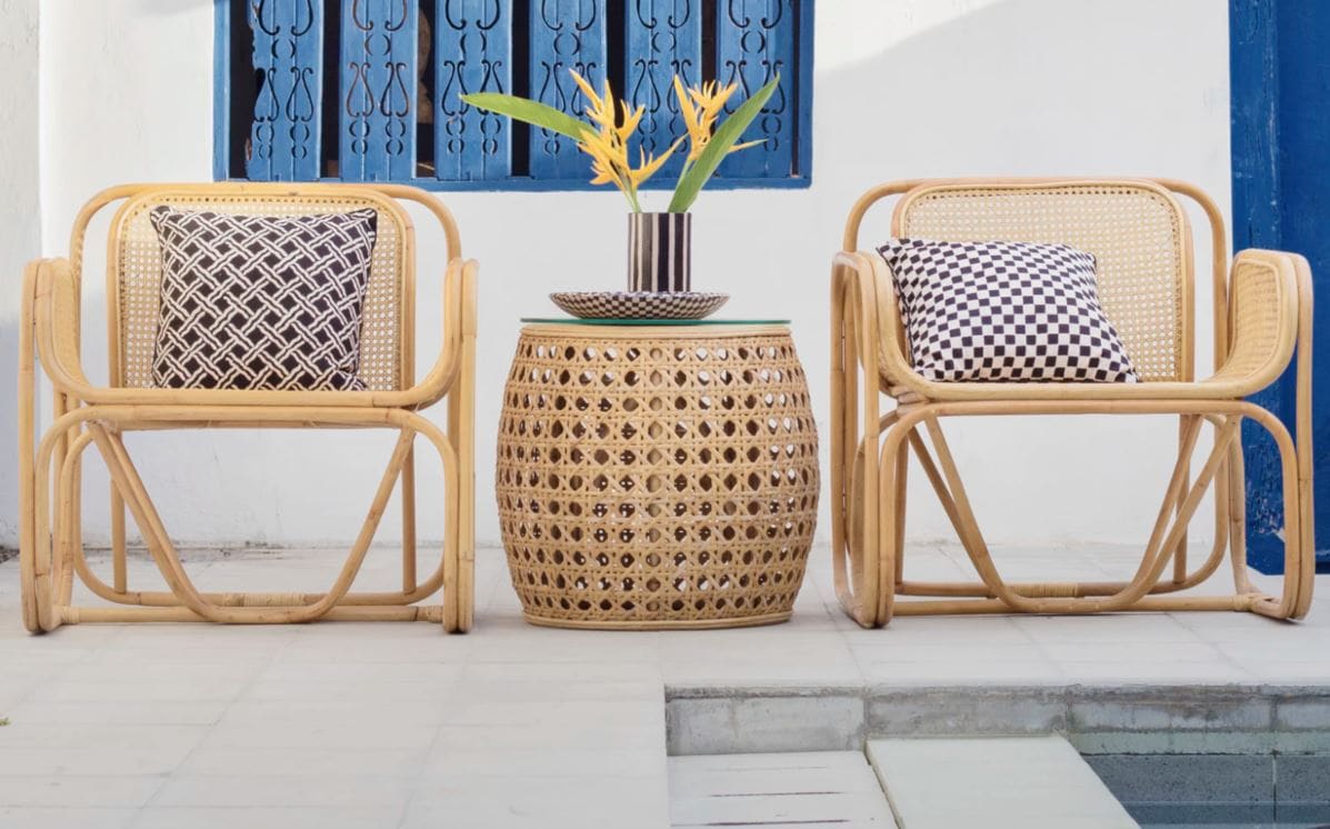 Two wicker chairs with checkered pillows