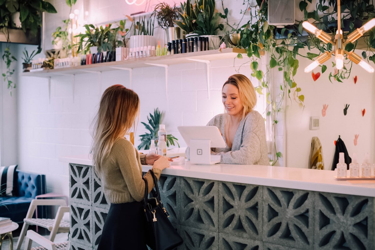 A woman paying at the counter