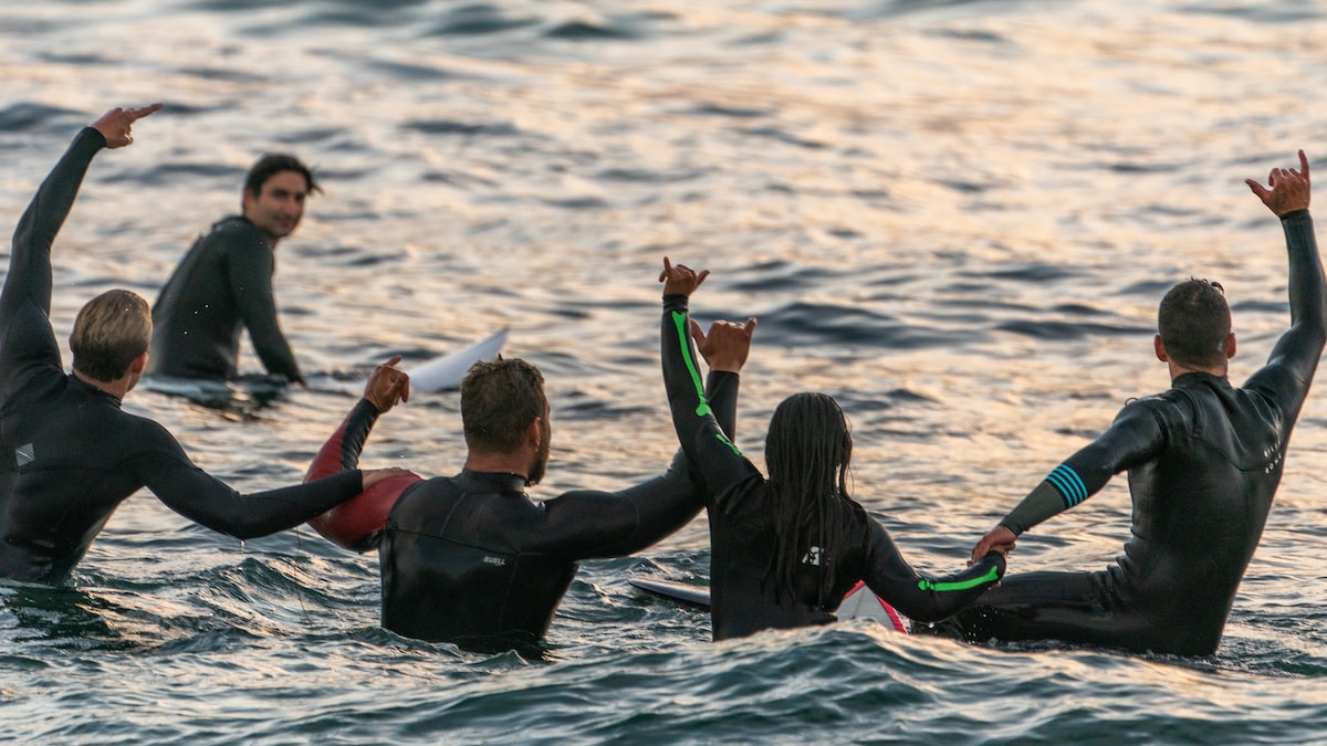 Group of men enjoying surfing in the ocean