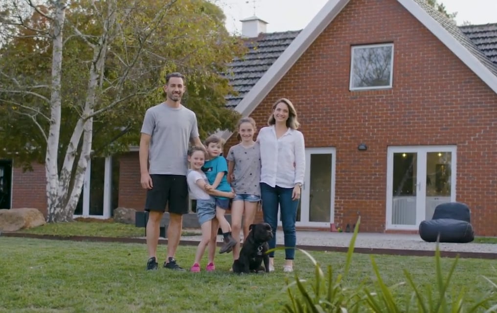 Valeri family standing outside their home