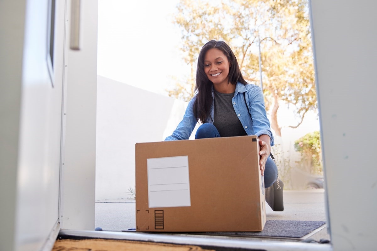 Woman at front door picking up home delivery