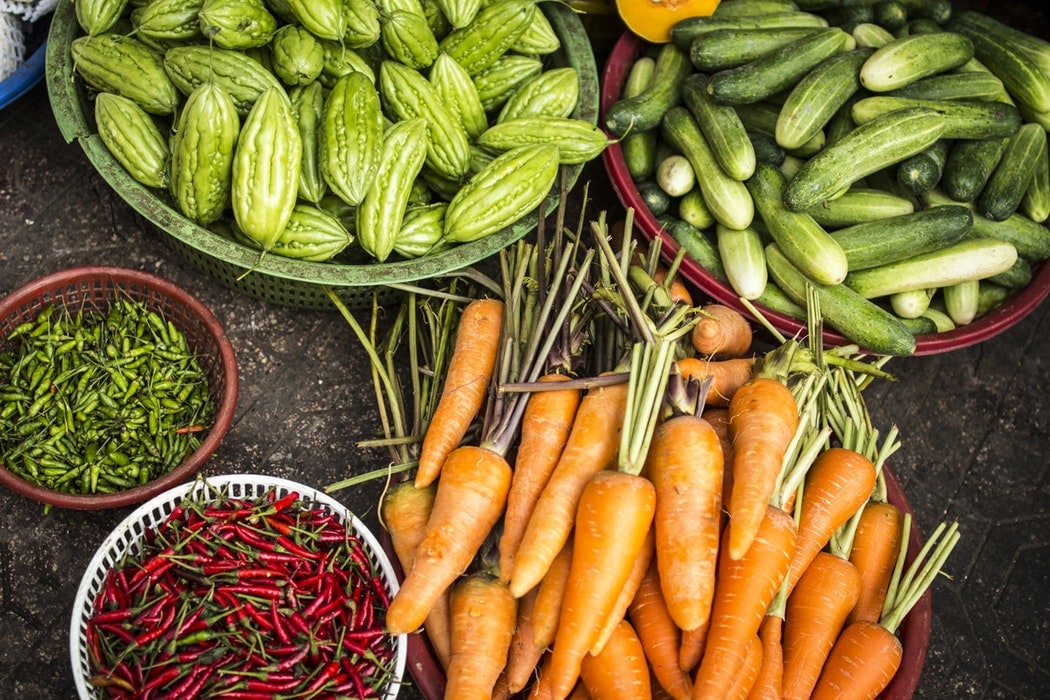 Plates of vegetables, including carrots, cucumbers and chilli