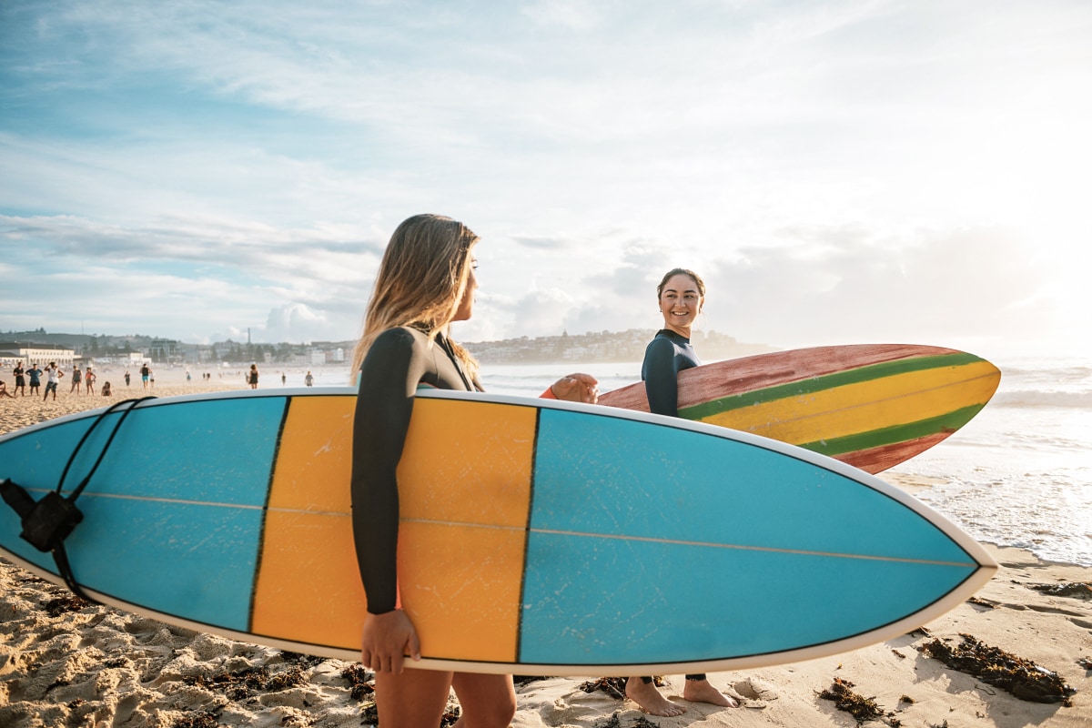 Two people taking a break from work to go surfing