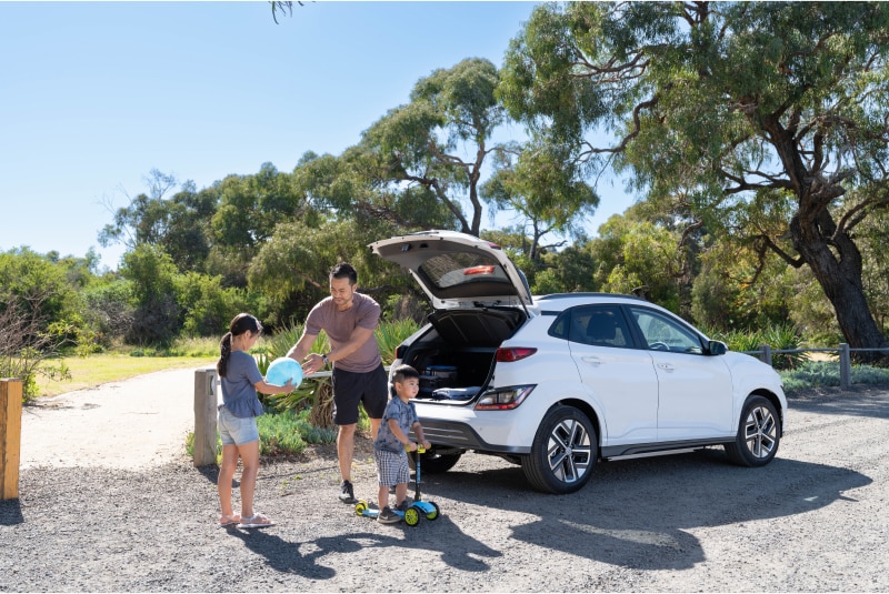 Man taking kids to the park, showing how roles at AGL can be flexible. 