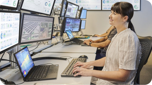 A woman looking at monitors