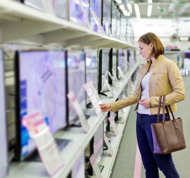 A woman reviewing the prices in-store at The Good Guys