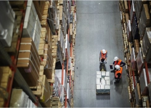 Birds eye shot of three people working in a warehouse