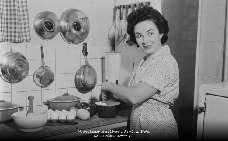 A black and white image of Margaret Fulton cooking in a kitchen.